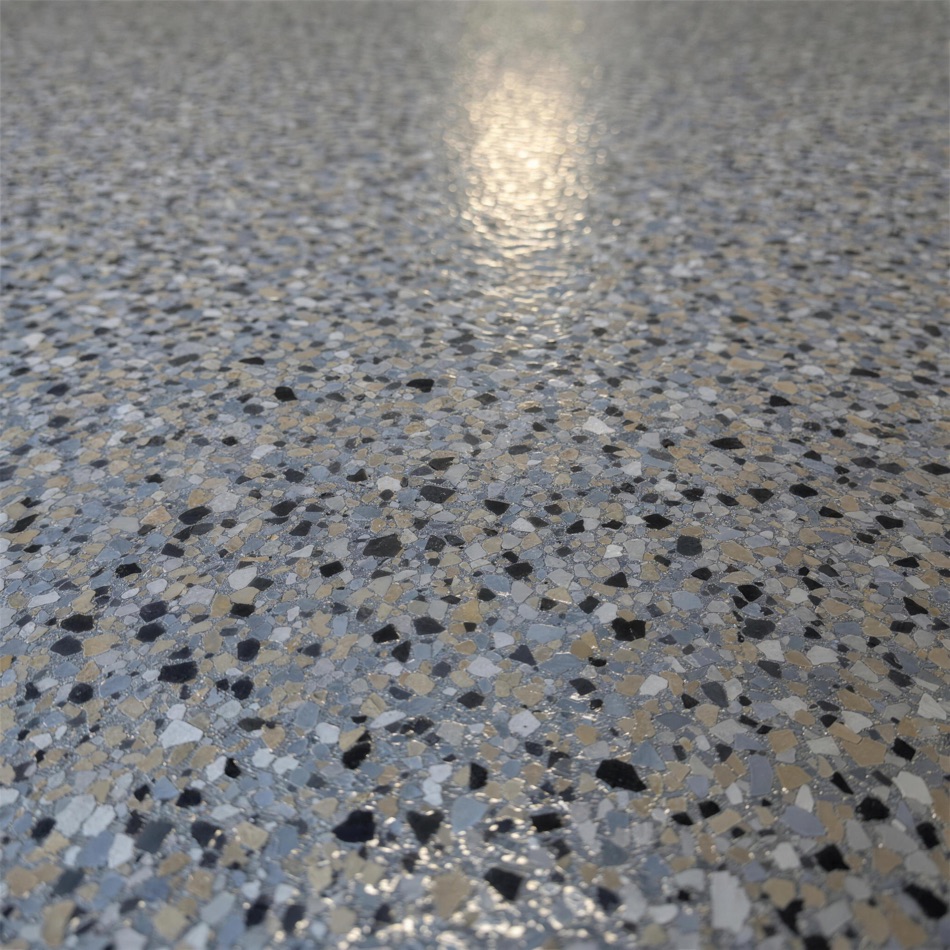 Macro photograph of a multi-tone decorative flake blend under a glossy top coat