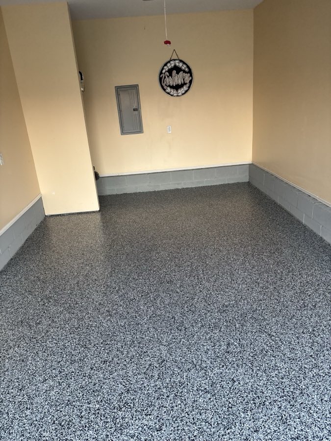 Coated garage floor meeting the painted base trim