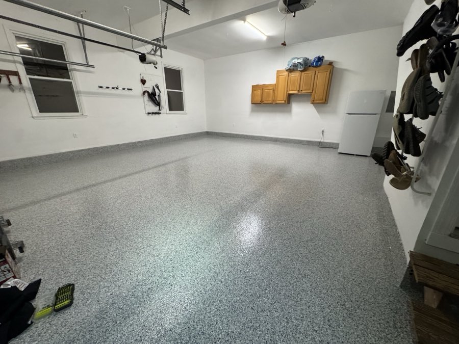 Wide view of a finished two-car garage with a gloss flake floor