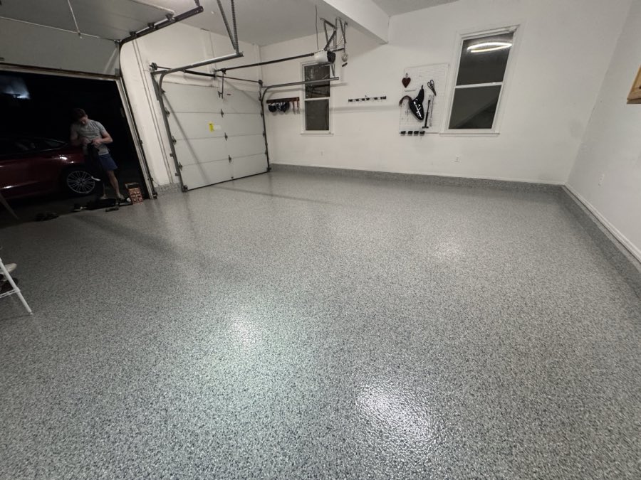 Finished garage floor reflecting the overhead lights